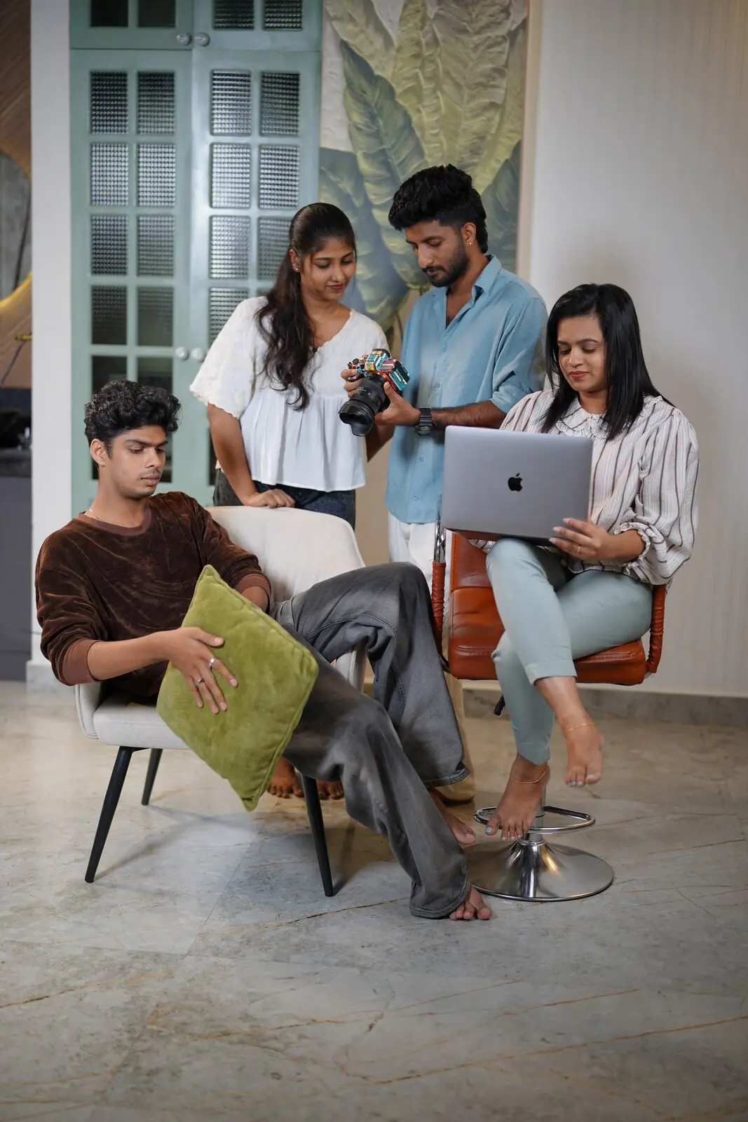 Fourart producers and designers reviewing camera footage